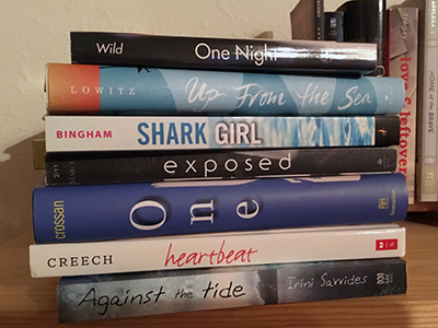 Spine Poem of Novels in Verse:One night/ up from the sea/ Shark Girl exposed/ one heartbeat/ against the tide. (by Sarah Tregay)